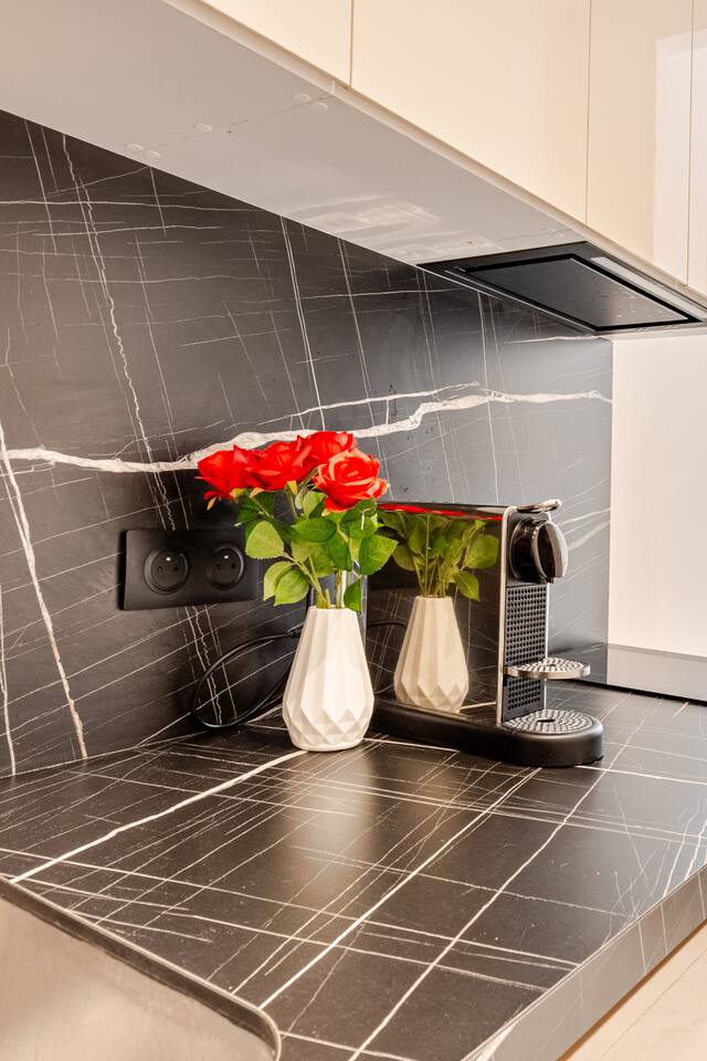 Black marble kitchen splashback with espresso coffee machine