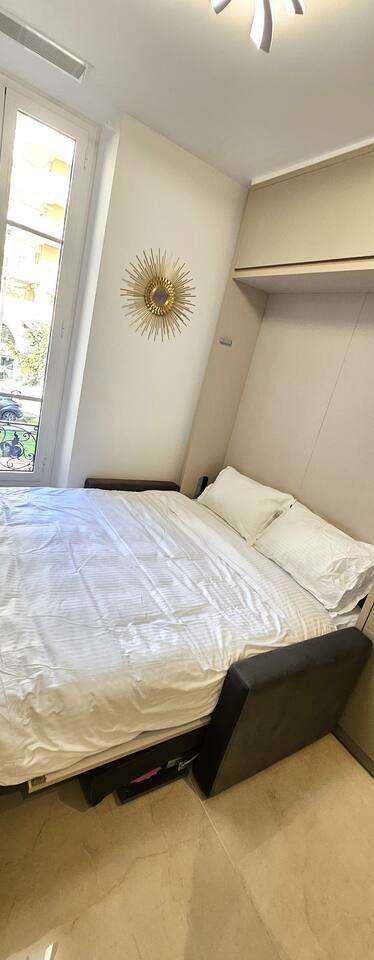 Fold-away double bed opened out in front of the window